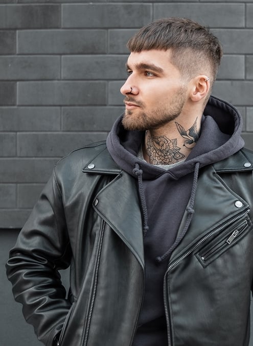 Мужчина со стрижкой кроп смотрит в телефон